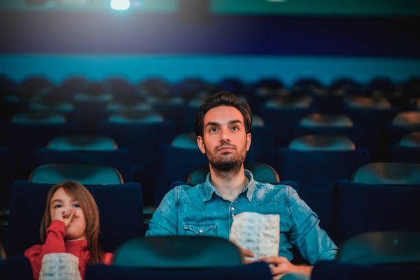 istock Father and daughter at the cinema 1212587689