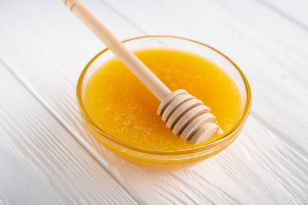 istock Sweet honey in a jar with dipper 1212587926