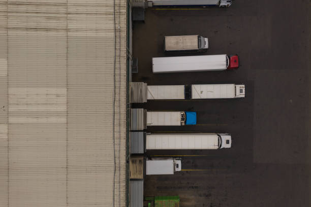 istock drone view of trucks and storage warehouse 1212588175
