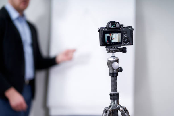 istock Young video blogger presenting important data on flipchart, online education concept 1212588304