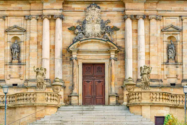 Grand doors of Dresden Frauenkirche in Germany. Entrance in high arch with a lot of sculpture in it and statues on walls. Architecture of Europe.