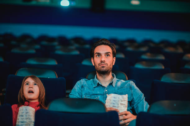 istock Father and daughter at the cinema 1212588885