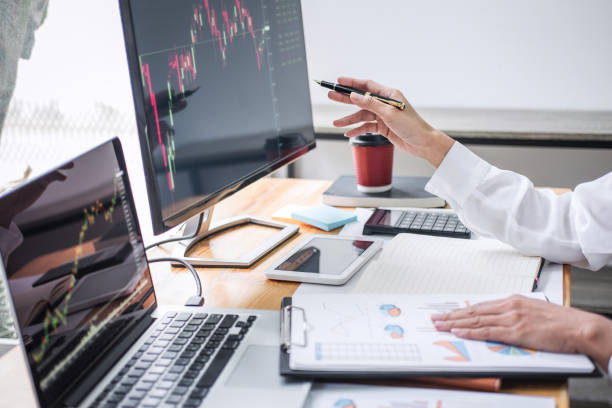 istock Businesswoman working with computer, laptop, thinking and analyzing graph stock market trading with stock chart data planning, financial and investment concept 1212590269