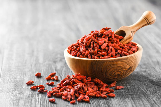 goji fresh fruits in wooden bowl on rustic table. - lycium chinese imagens e fotografias de stock