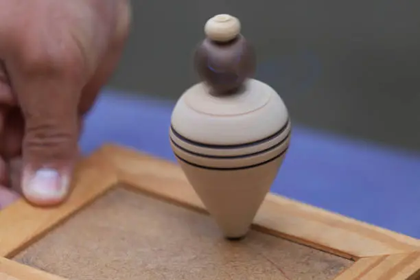 Close-up of a wooden spinning top. Vintage toy