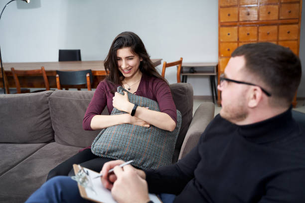 istock Female patient talking to her therapist who is making notes in home private office 1212594622