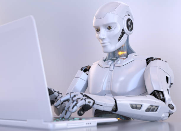 Robot working with laptop stock photo