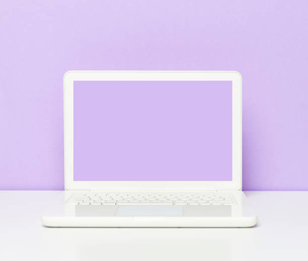 istock Purple Screen Laptop On The Office Desk 1212596595