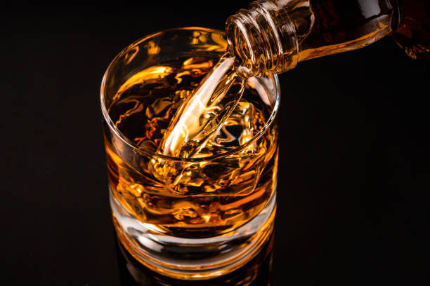 istock glass of whiskey on black 1212596723