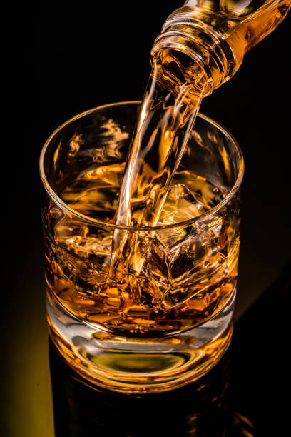 istock glass of whiskey on black 1212597271