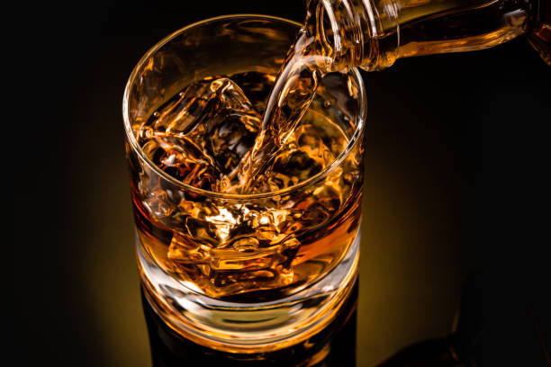istock glass of whiskey on black 1212597272