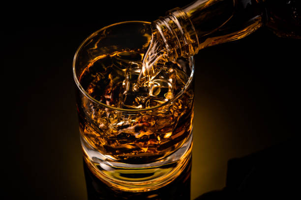 istock glass of whiskey on black 1212597352