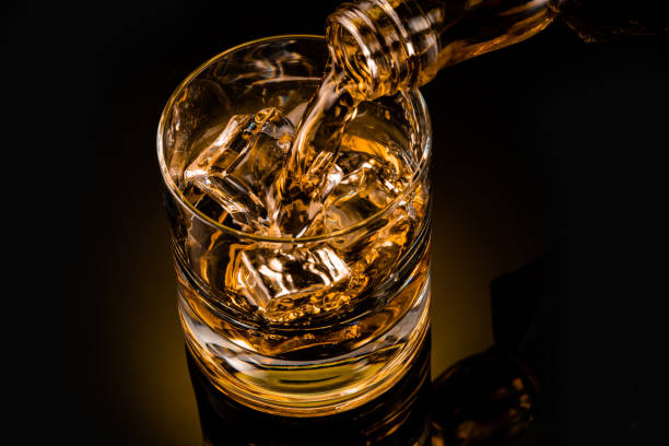 istock glass of whiskey on black 1212597411