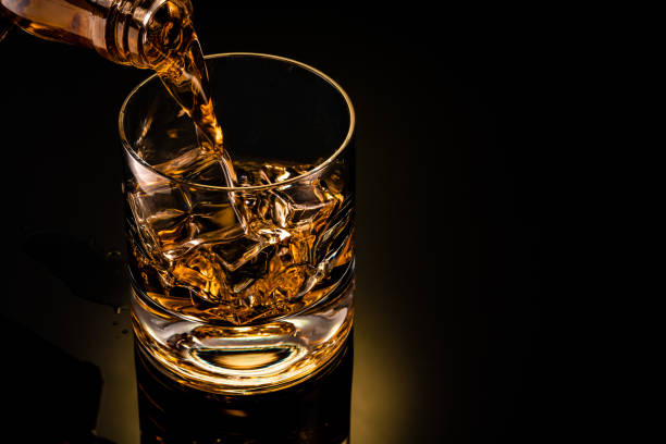 istock glass of whiskey on black 1212597511