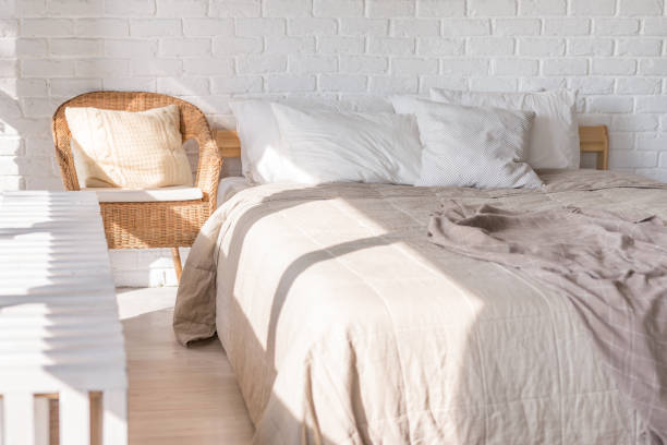 istock Home interior, bedroom in soft light colors with double bed, bedspread. pillows 1212597520