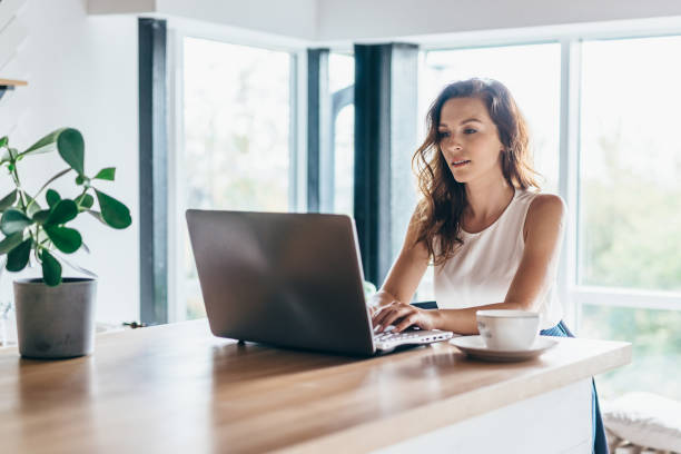 Woman using laptop while sitting at home