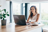 Woman using laptop while sitting at home