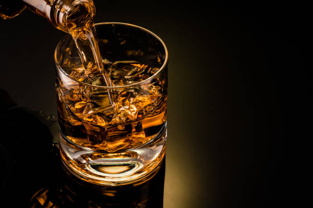 istock glass of whiskey on black 1212597627