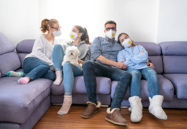 Family at sofe with mask in quarantine isolation against virus Family at home sofa with mask in quarantine isolation against virus COVID-19 Coronavirus Corona Virus sofe stock pictures, royalty-free photos & images