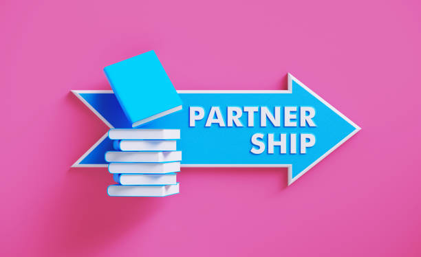 istock Book Stack Sitting over A Blue Arrow Shaped Directional Sign on Pink Background 1212599581