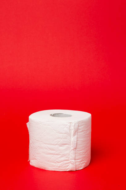 istock Toilet Paper isolated on red background 1212600889
