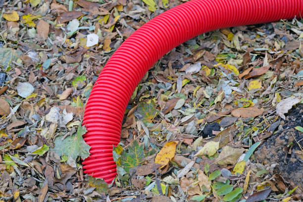 istock Red flexible double-walled pipe for cable ducts. A corrugated plastic pipe 1212601132