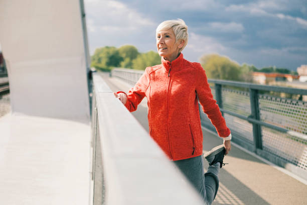 istock Senior woman stretching before run 1212602894