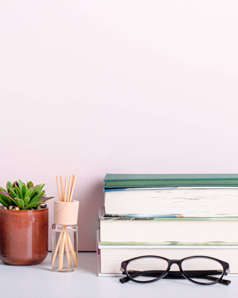 istock Multicolor books stack, house plants succulents and fragrant candle and sticks. Background for World Book Day. Still life with stack of colorful books and home interior decor 1212605051