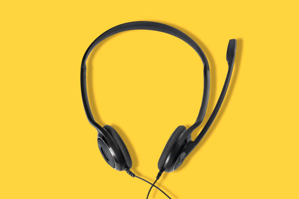 istock Headphones with a microphone on a yellow background. Top view. 1212605093