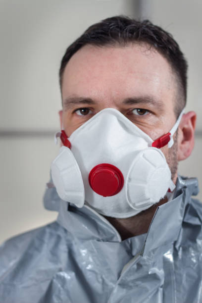 istock Face of a man with a protective mask on his face. A man wearing a protective suit. 1212605377