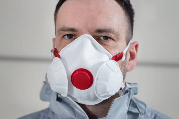 istock Face of a man with a protective mask on his face. A man wearing a protective suit. 1212605382