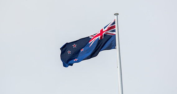 The national flag of New Zealand flying over Auckland.