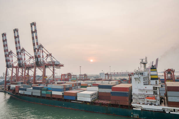 istock Cargo ship anchored in cargo container in warehouse port. 1212606362
