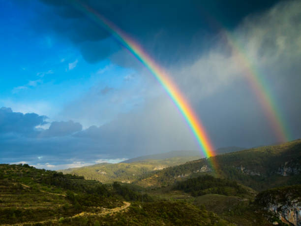 istock View of the mountains and a double rainbow. 1212606432