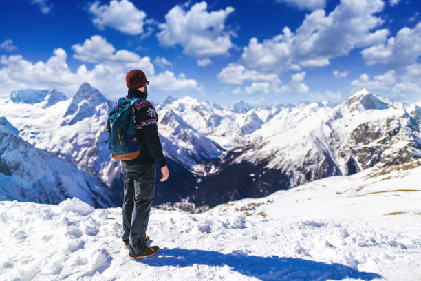 istock Tourist exploring snowy mountains 1212606597