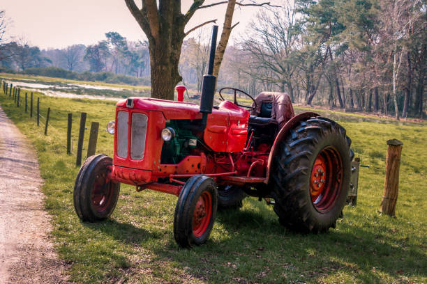 istock Old red vintage tractor on the land 1212606639