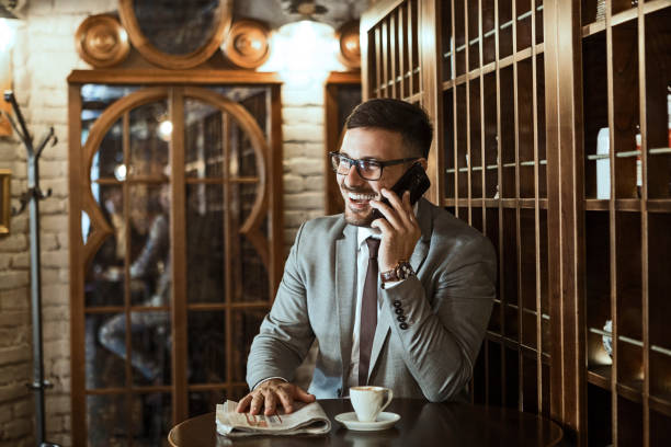 istock Businessman in cafe on a coffee break talking on a smart phone 1212606647