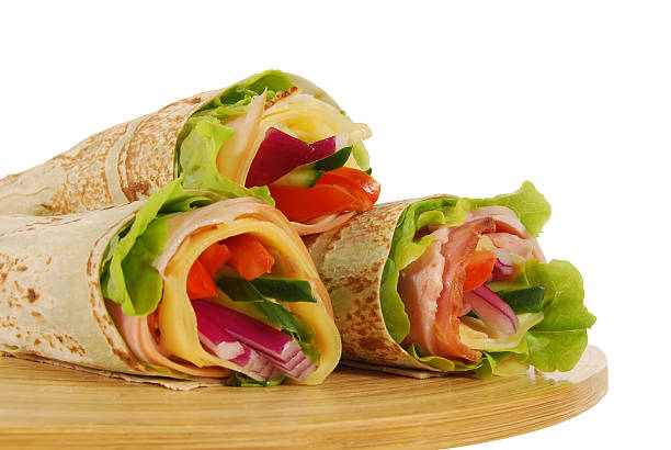 istock Three wrap sandwiches on wooden tray 121260926