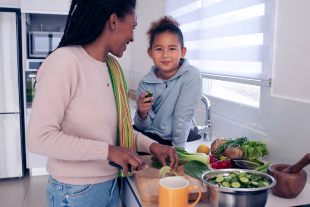 istock Mother and daughter cooking together. 1212609700