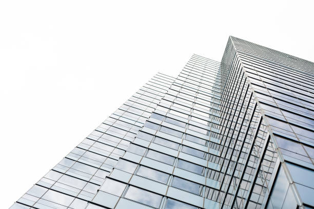 istock Low angle view of modern office building, skyscraper, white background with copy space 1212610842