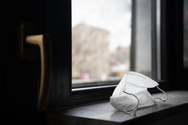 protection medical face mask by the window stock photo