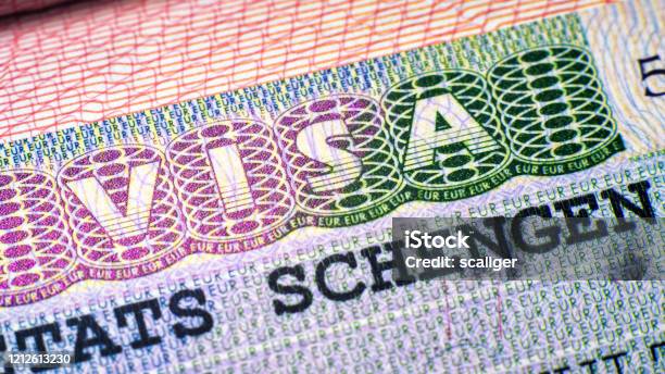 Visa Stamp In Passport Closeup European Visitor Visa At Border Control Macro View Of Schengen Visa For Tourism And Travel In Eu Stock Photo - Download Image Now