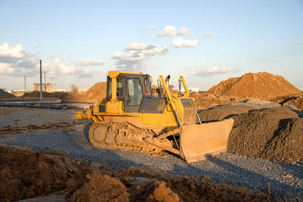 istock Dozer working at construction site. Bulldozer for land clearing, grading, pool excavation, utility trenching and foundation digging. 1212613904