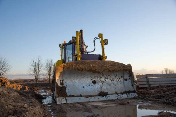 istock Dozer working at construction site. Bulldozer for land clearing, grading, pool excavation, utility trenching and foundation digging 1212613955