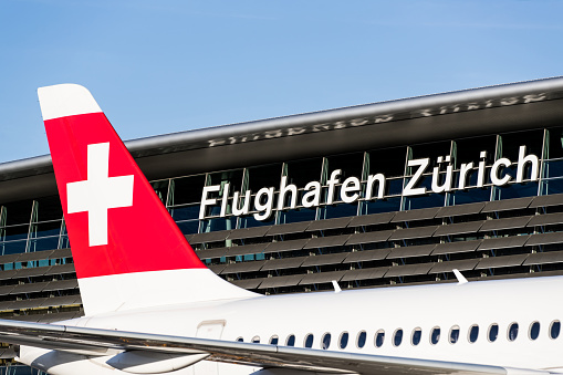 Zurich, Switzerland - March 15, 2020: Overview of Zurich Airport with a Swiss International Air Lines airplane parked at the gate. Zurich Airport is the largest international airport of Switzerland and the principal hub of Swiss International Air Lines.