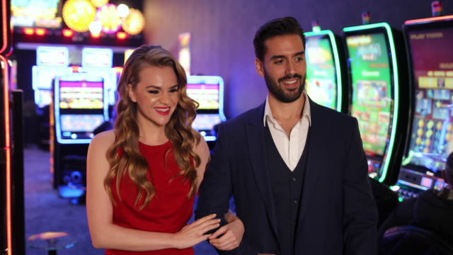 Beautiful couple walking through casino