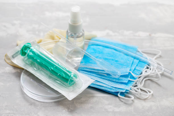 istock medical mask, plastic cups and other medical objects in ceramic background 1212617547