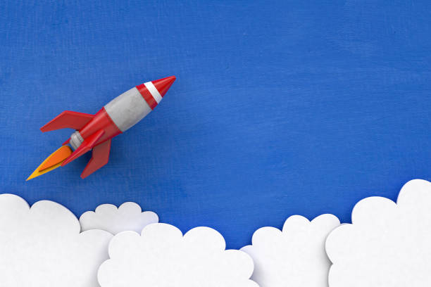 istock 3D Cartoon Rocket on Painted Blue Background with Clouds 1212618740