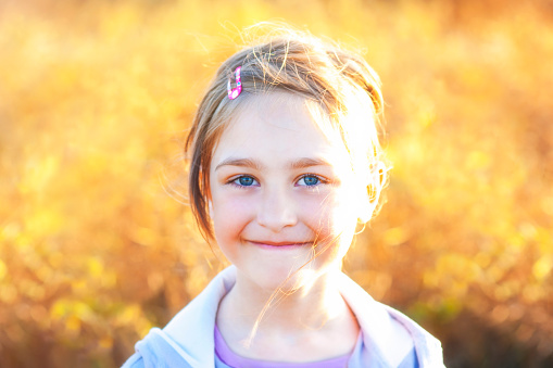 Summer girl portrait on yellow blurred sunset background meadow. Shallow Depth of Field. SDF.