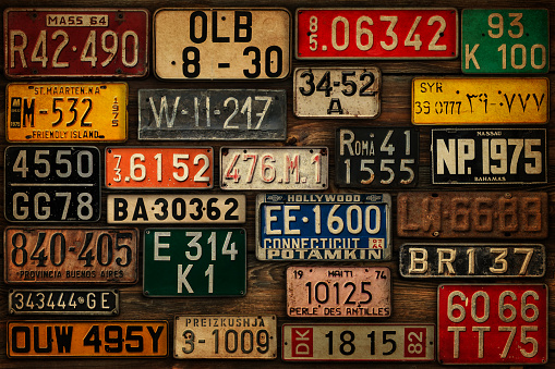 Various retro License Plates on the wooden wall.
